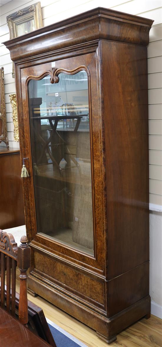 A 19th century French burr walnut bookcase, enclosed by a single glazed door, H.206cm W.107cm H.206cm W.107cm